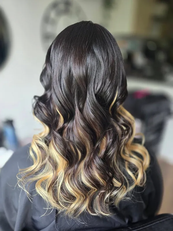 Dark hair with blonde balayage curls